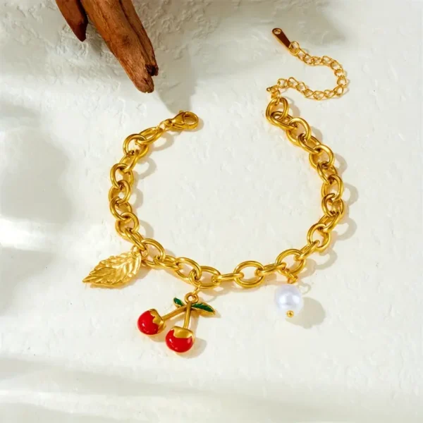 8d792ef9-5b6d-4b1d-8208-18b70766f5dc Bracelet en acier inoxydable doré élégant avec pendentif cerise et feuille rouge