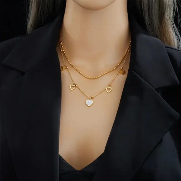 8e08ba39-3d2a-4e6b-a44c-f80315da0ac2 Collier Double Couche Minimaliste avec Pendentif Cœur Ajouré