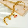 Bracelet en acier inoxydable doré élégant avec pendentif cerise et feuille rouge